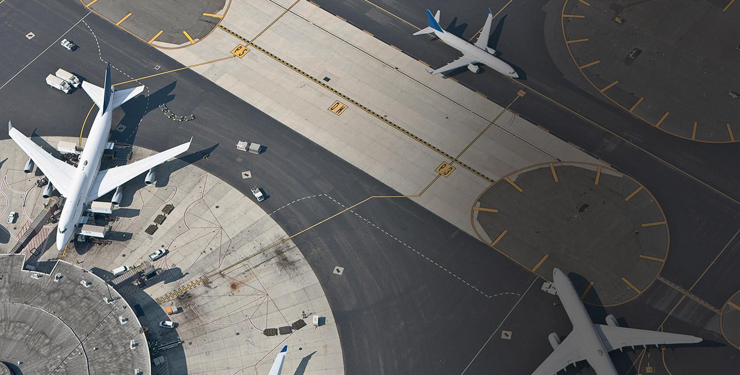 Aerial view of three commercial planes at an airport